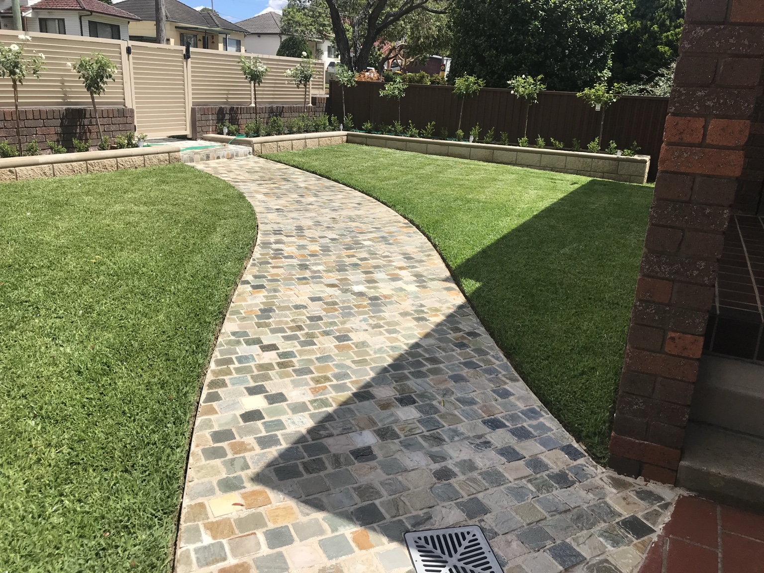 Curved stone pathway & lawn