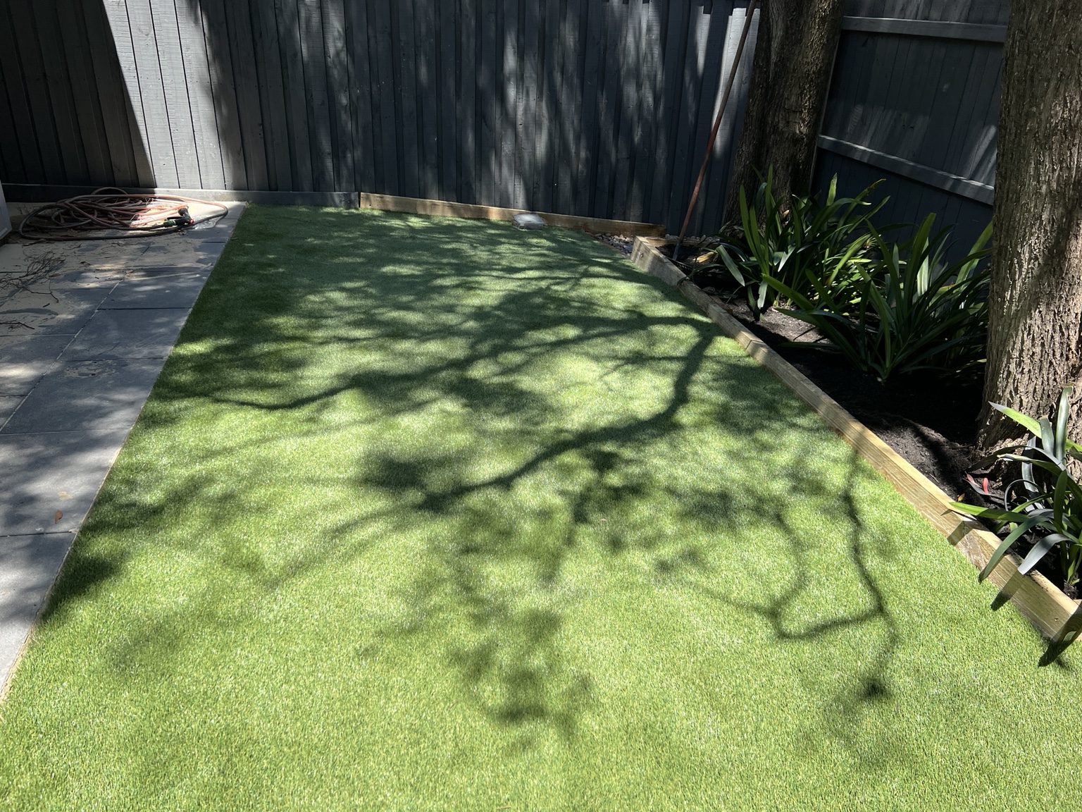 Artificial lawn in a shaded garden